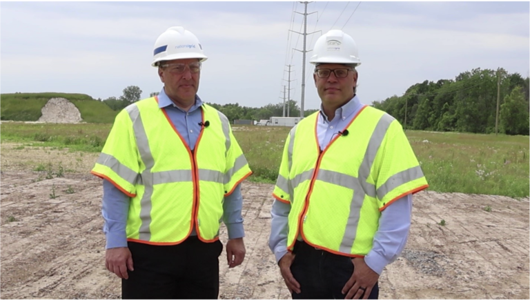 Two smiling National Grid employees